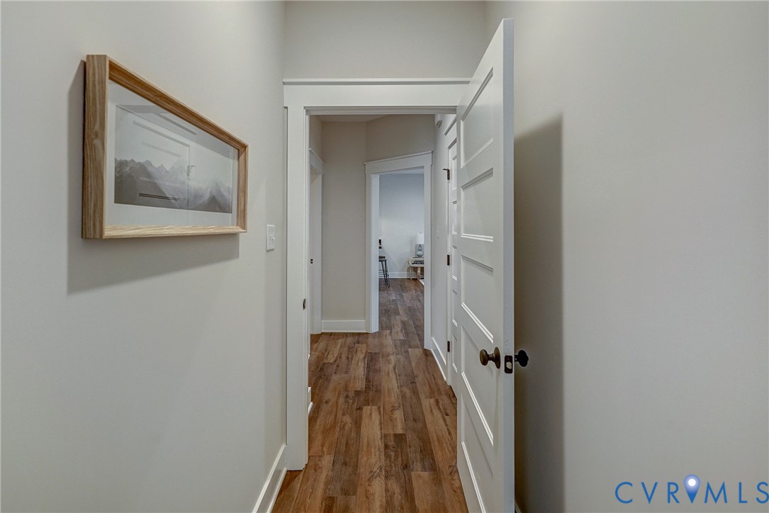 1343 Stokes Station Road Goochland, VA 23063 - Photo 29 of 35 a view of a hallway with wooden floor and a bathroom