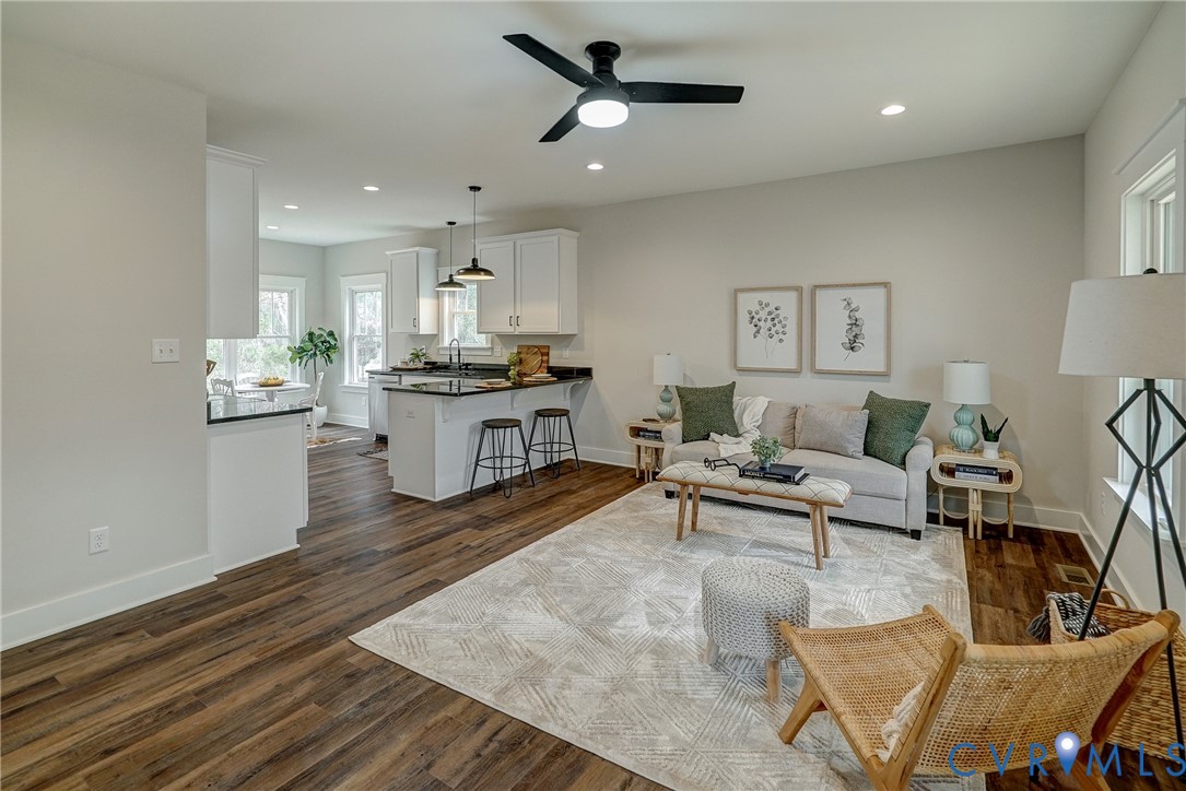 1343 Stokes Station Road Goochland, VA 23063 - Photo 9 of 35 a living room with kitchen island furniture and a wooden floor