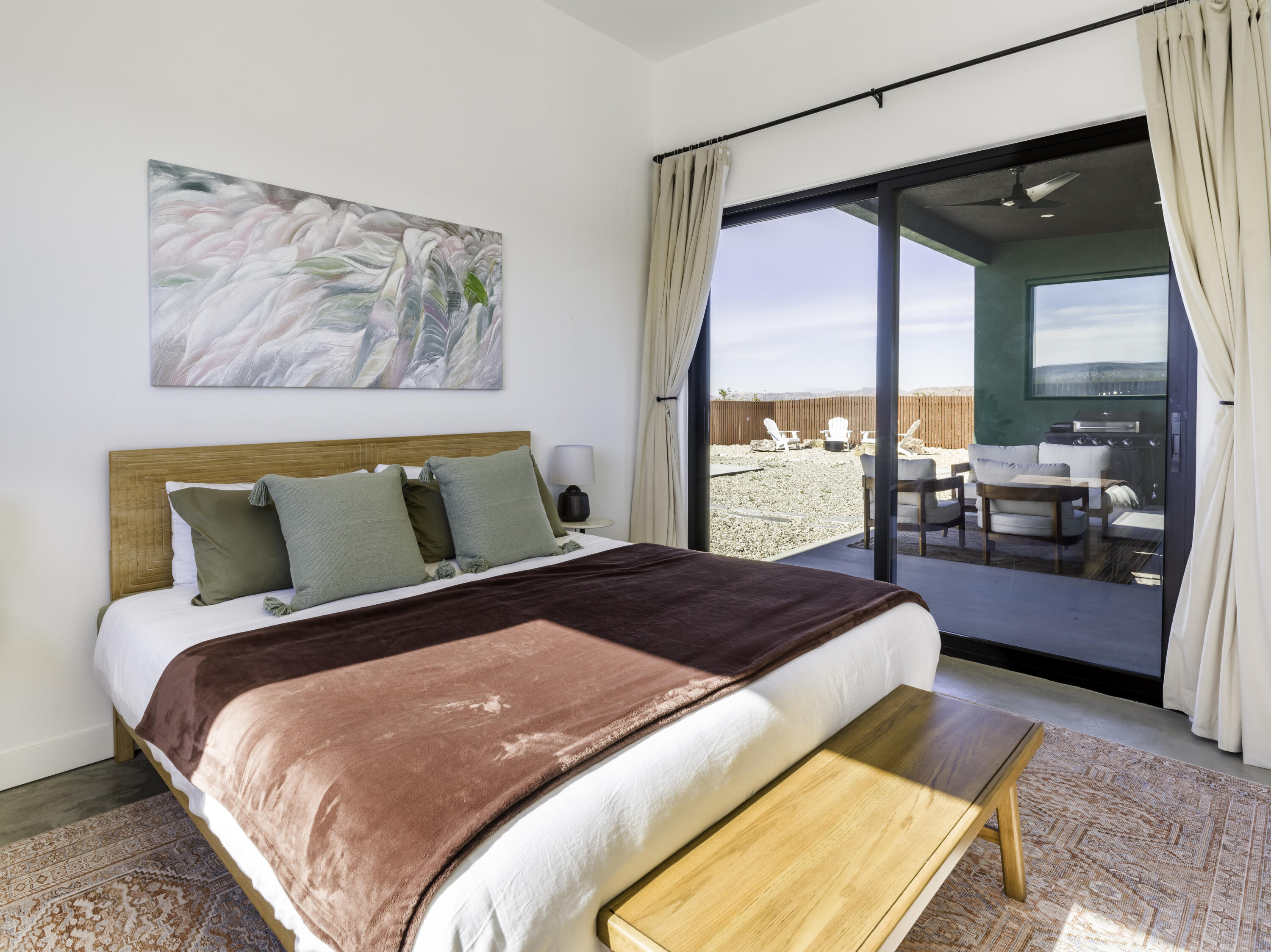 59130 Reche Road Landers, CA 92285 - Photo 16 of 69 a bedroom with a large bed and a balcony