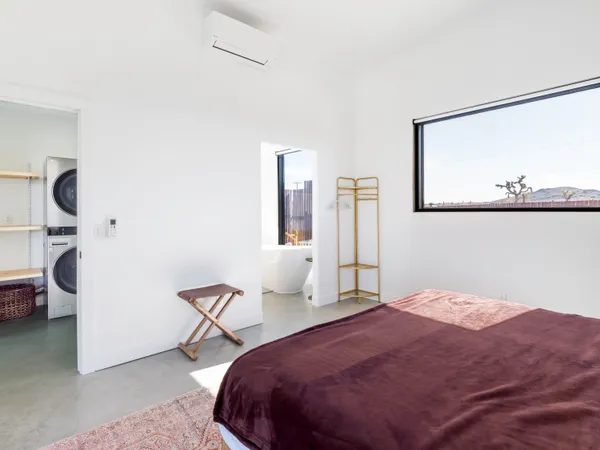 a bedroom with a bed and a painting on the wall