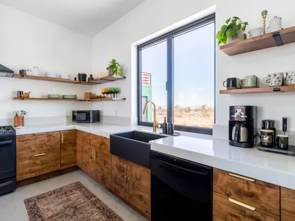a kitchen with a large window and stainless steel appliances