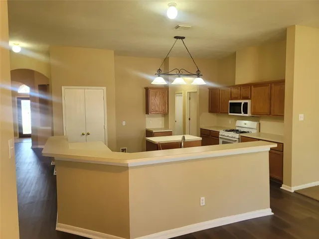 a room with counter top space and stainless steel appliances