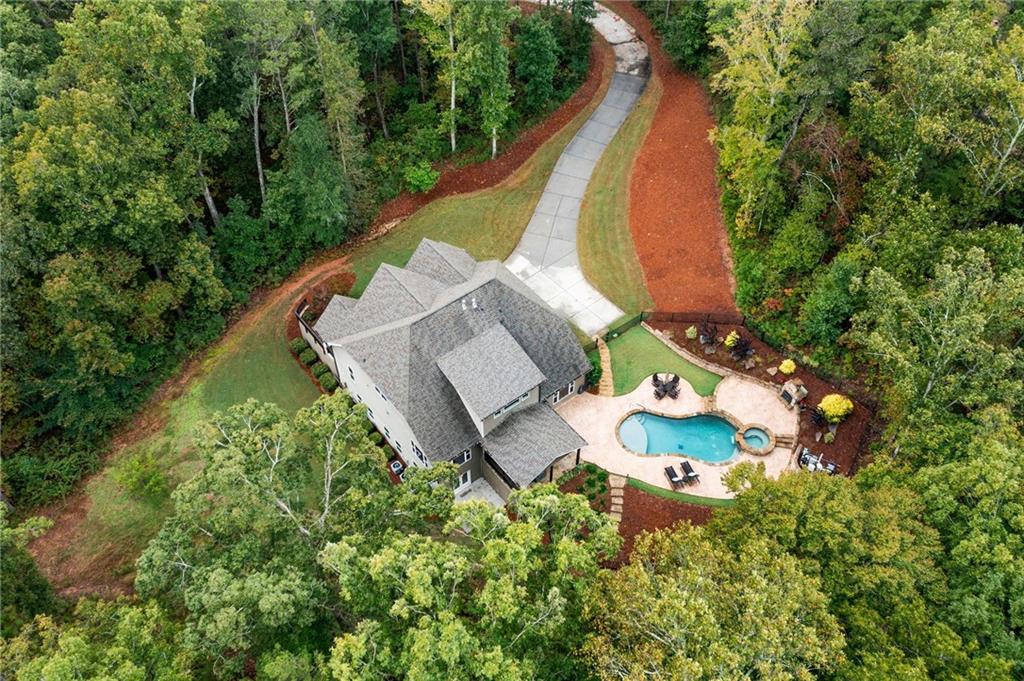 an aerial view of a house with a garden and swimming pool