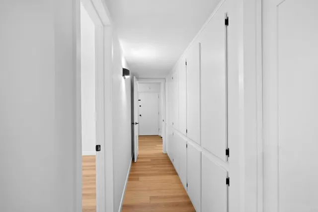 a view of a hallway with a wooden door