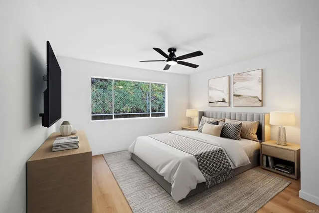 a bedroom with a large bed and a flat screen tv