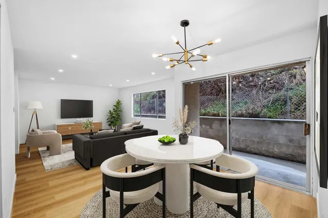 a view of a dining room with furniture window and wooden floor