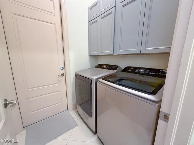 a view of a backyard with swimming pool and furniture