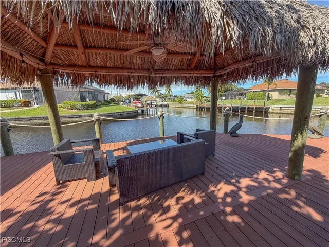 a view of a patio with couches table and chairs and potted plants