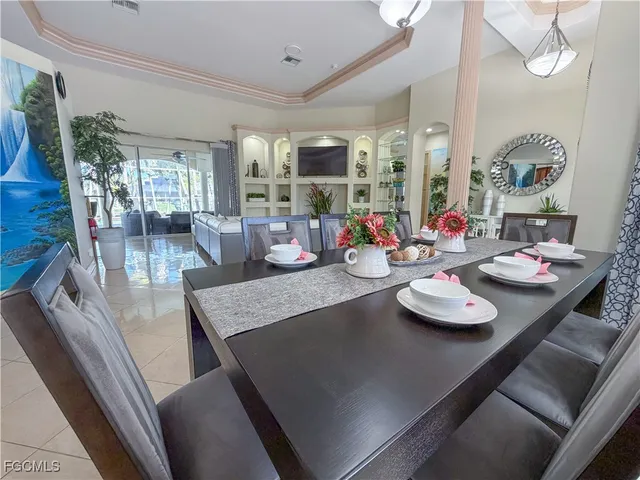a view of a dining room with furniture wooden floor and a chandelier