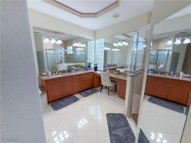 a spacious bathroom with a granite countertop sink and a mirror