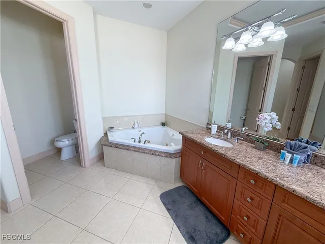 a bathroom with a granite countertop sink a mirror and a shower