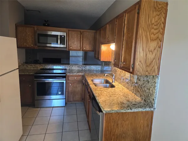 a kitchen with a stove and a microwave
