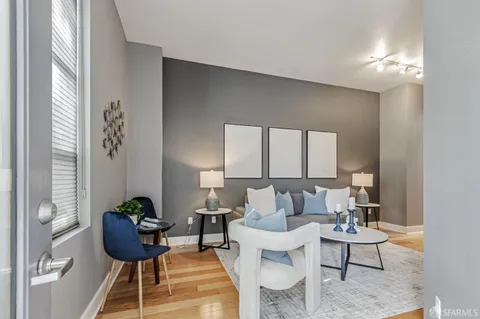 a living room with furniture and a potted plant