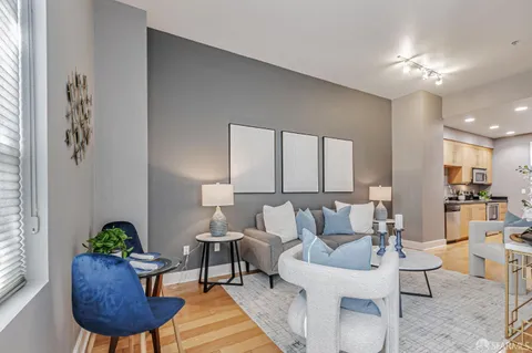 a living room with furniture and a potted plant