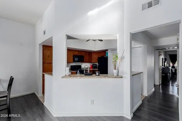 a kitchen with granite countertop a refrigerator and a sink