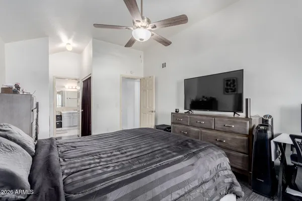 a bedroom with a bed and a chandelier