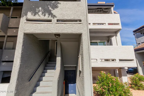 a view of a building with entryway and stairs
