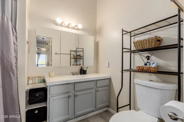 a bed room with a bed and a flat tv screen on a dresser
