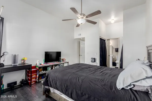 a bedroom with a bed and a flat screen tv