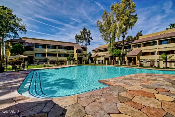 a view of a backyard with sitting area