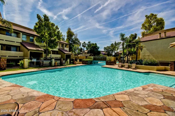 a swimming pool with outdoor seating and yard