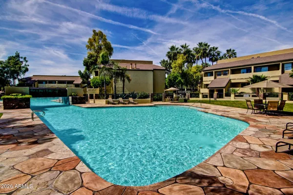 a view of a house with backyard porch and sitting area