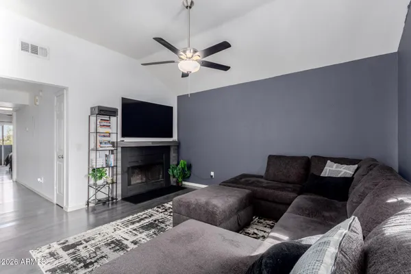 a living room with furniture a fireplace and a flat screen tv