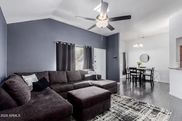 a living room with furniture wooden floor and a chandelier
