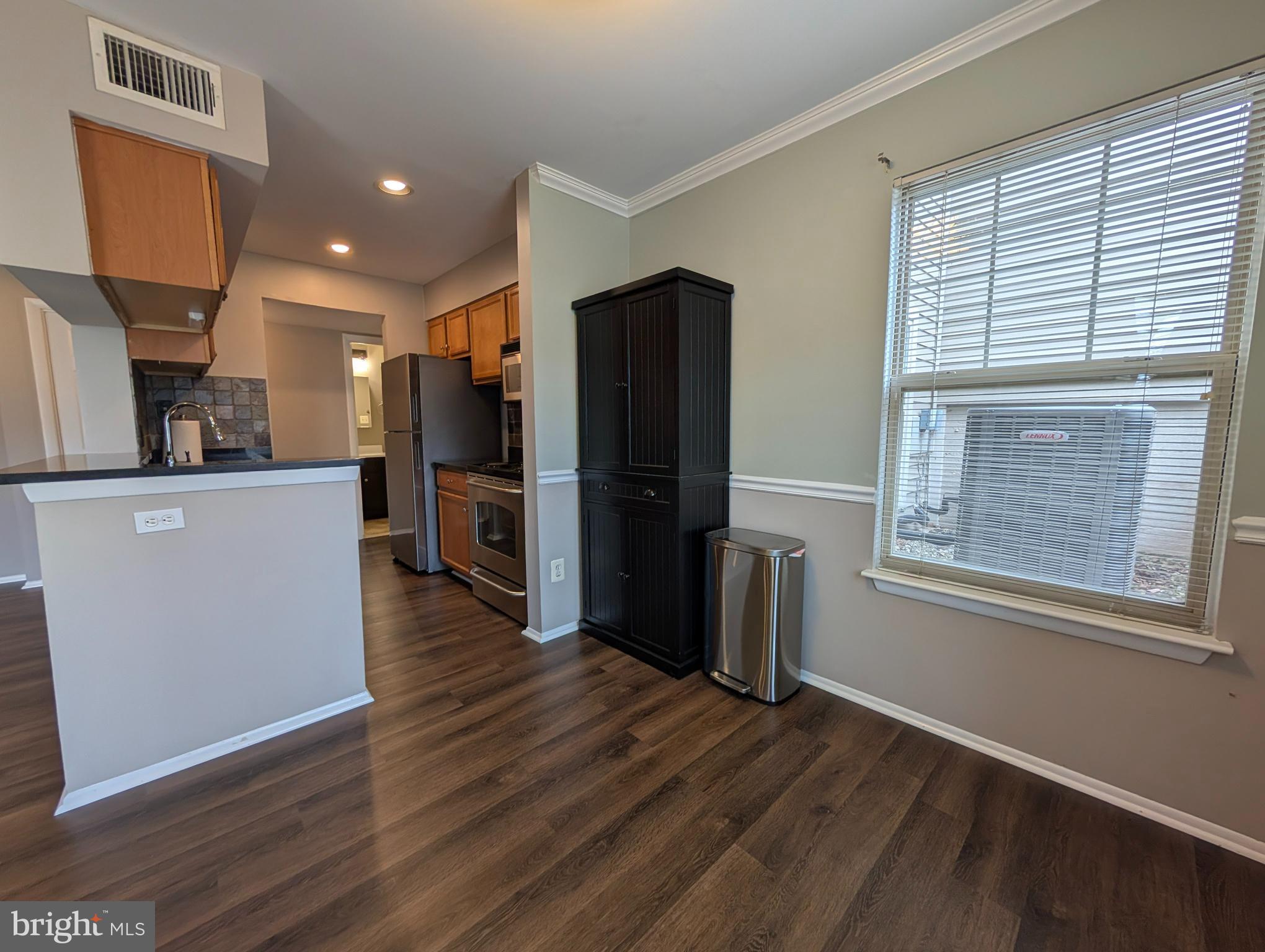 1708 Abercromby Court, Unit 1708B Reston, VA 20190 - Photo 11 of 26 a view of a kitchen with a refrigerator a microwave and a sink