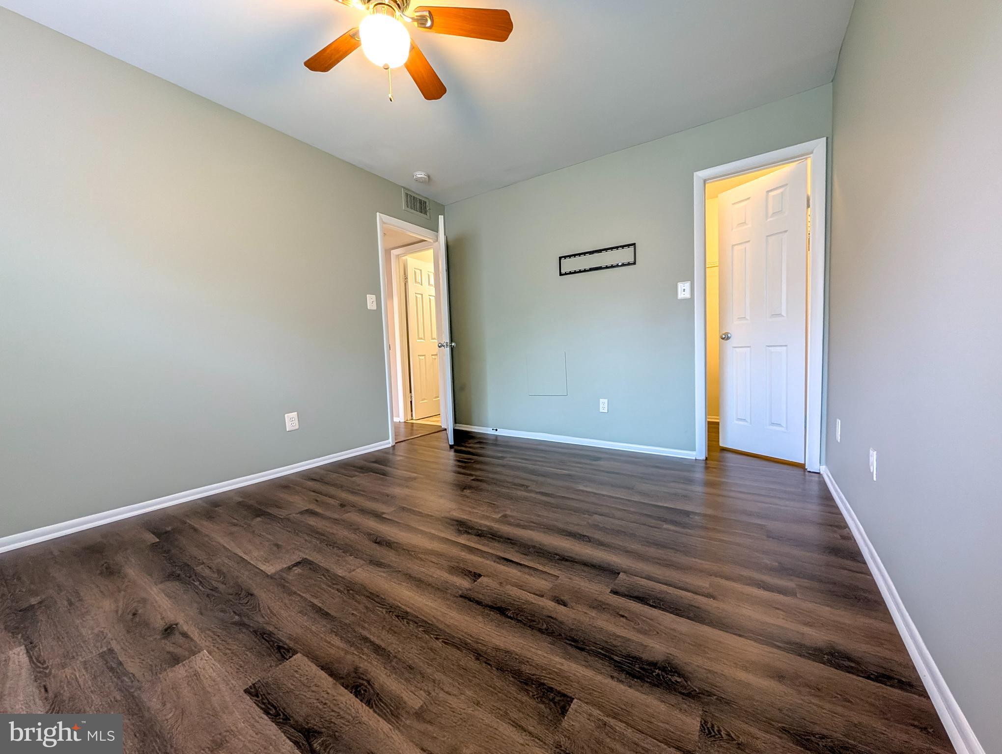 1708 Abercromby Court, Unit 1708B Reston, VA 20190 - Photo 12 of 26 wooden floor in an empty room with a window