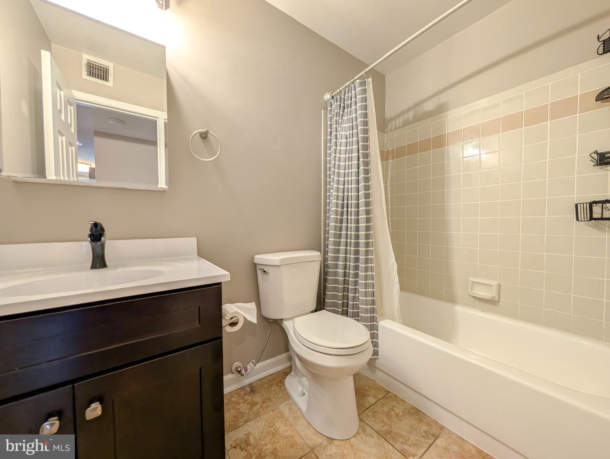 1708 Abercromby Court, Unit 1708B Reston, VA 20190 - Photo 14 of 26 a bathroom with a sink toilet and shower