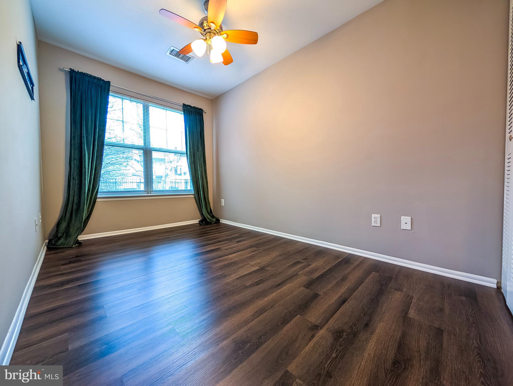 1708 Abercromby Court, Unit 1708B Reston, VA 20190 - Photo 15 of 26 an empty room with wooden floor and windows