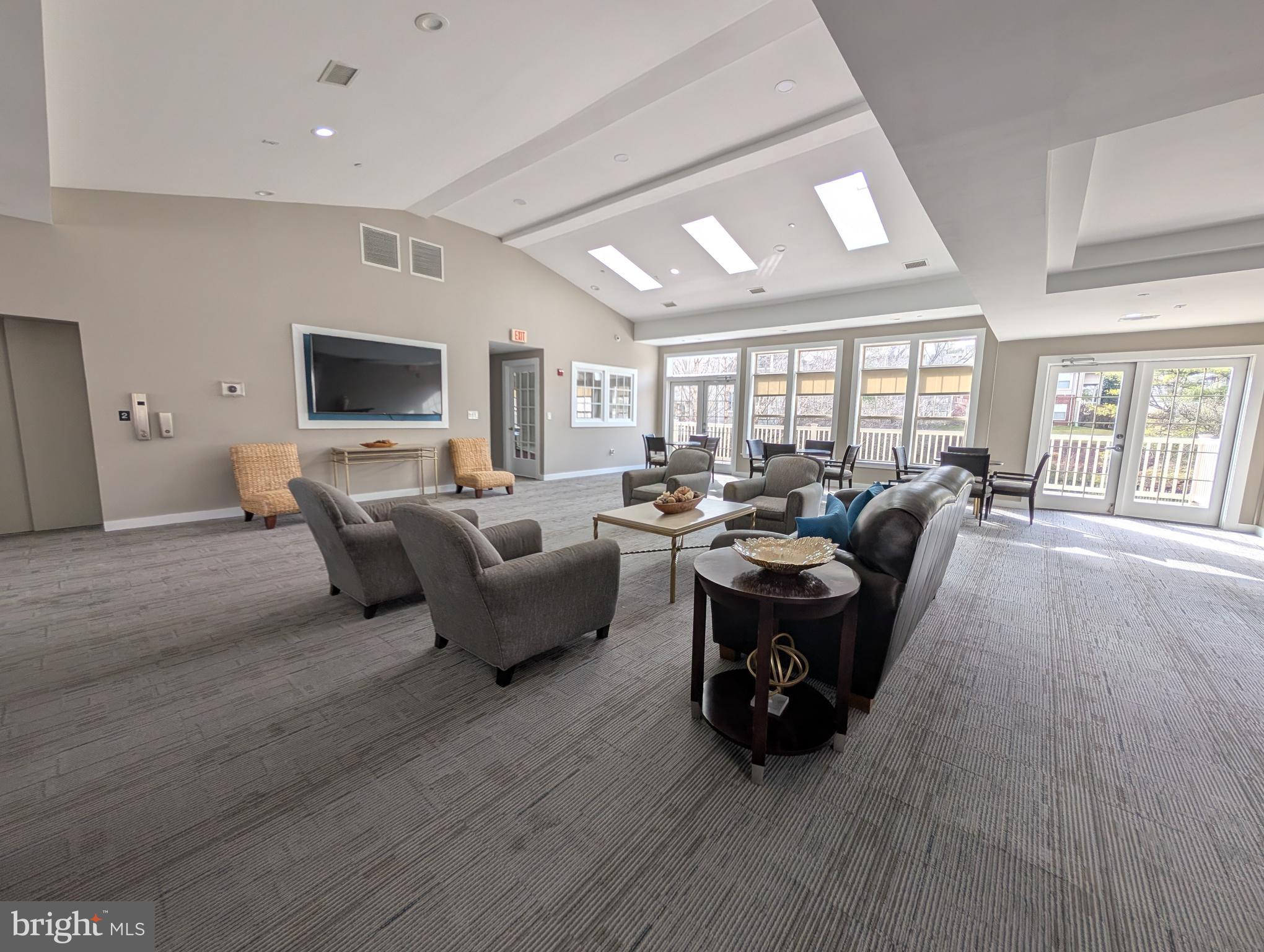 1708 Abercromby Court, Unit 1708B Reston, VA 20190 - Photo 18 of 26 a living room with furniture flat screen tv and a large window