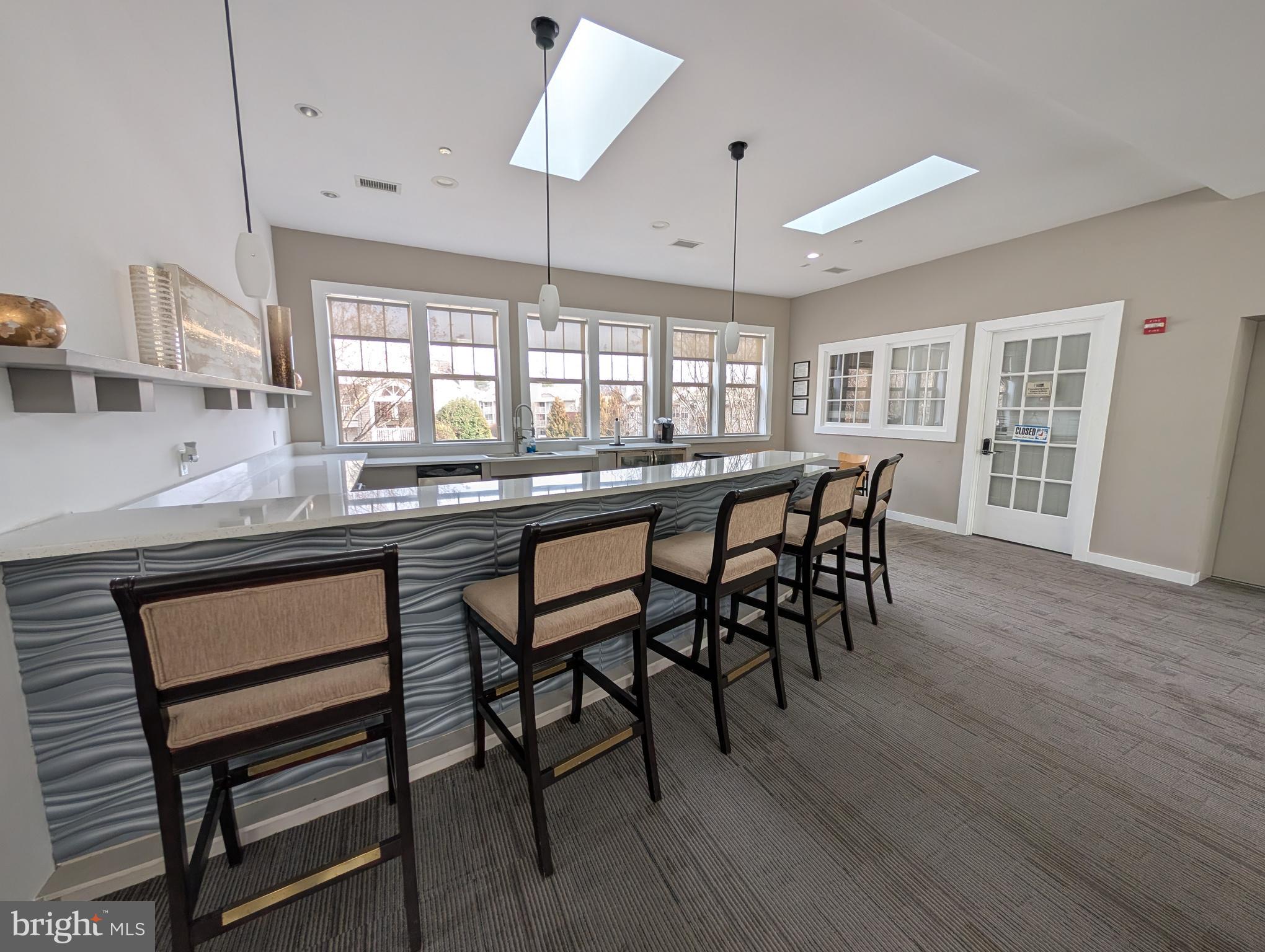 1708 Abercromby Court, Unit 1708B Reston, VA 20190 - Photo 19 of 26 a kitchen with stainless steel appliances granite countertop wooden floor dining table and chairs