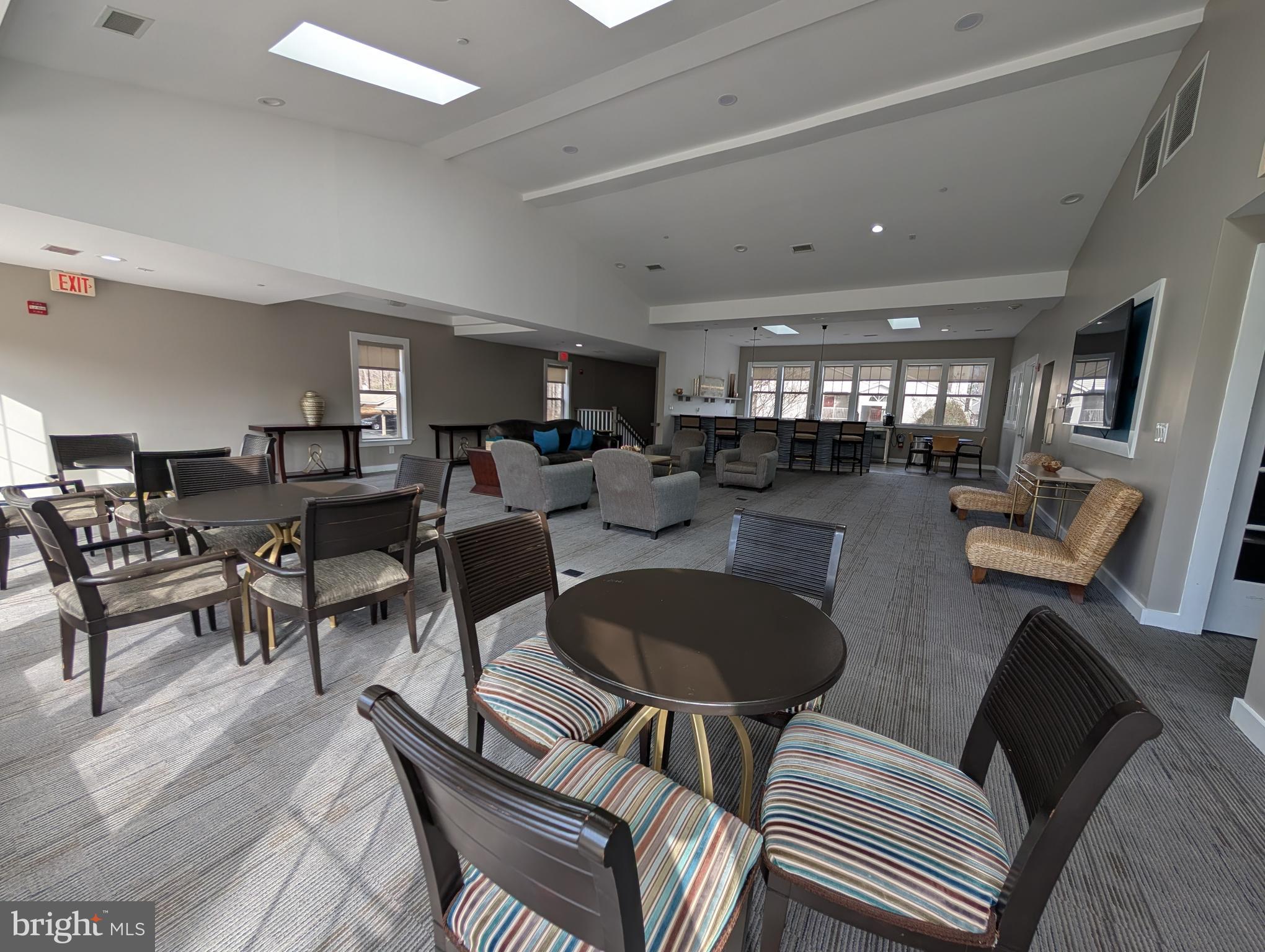 1708 Abercromby Court, Unit 1708B Reston, VA 20190 - Photo 23 of 26 a living room with lots of furniture and a chandelier