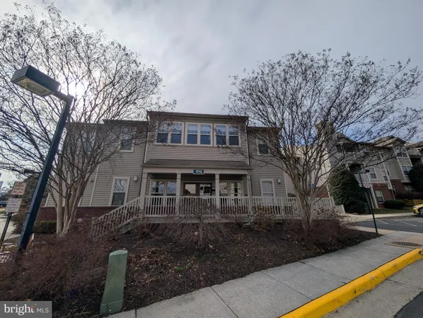 a front view of a house with yard and green space