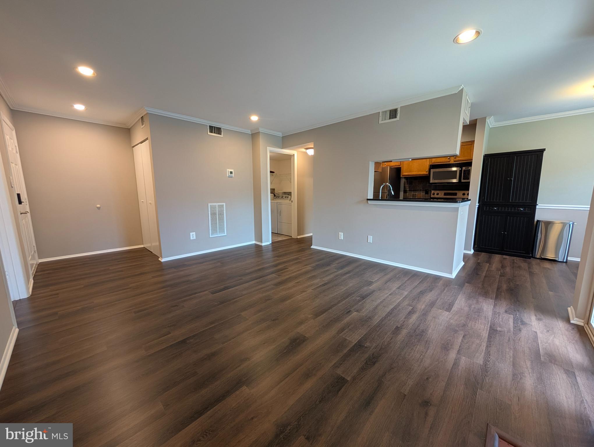 1708 Abercromby Court, Unit 1708B Reston, VA 20190 - Photo 4 of 26 a view of a livingroom with wooden floor