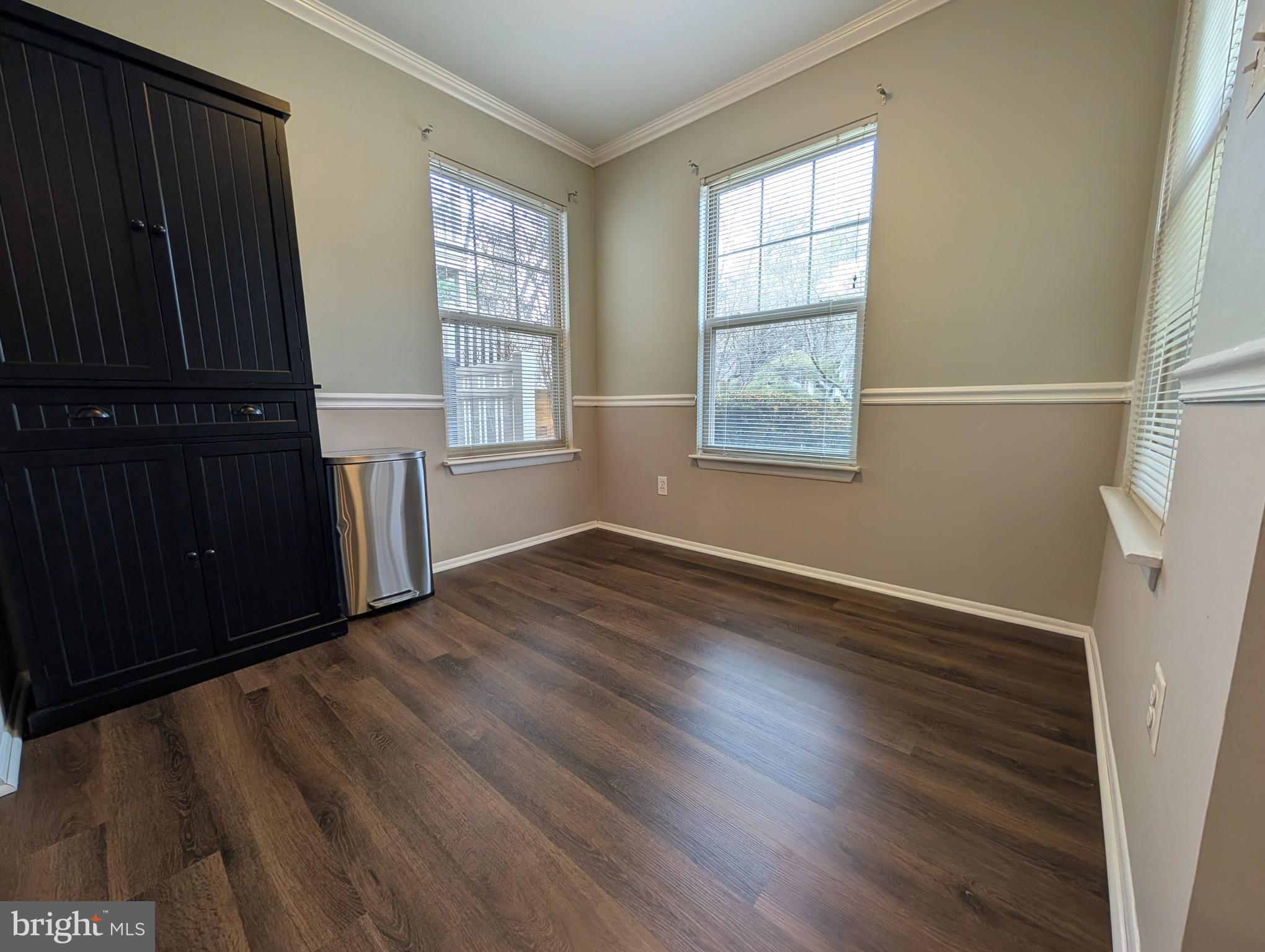 1708 Abercromby Court, Unit 1708B Reston, VA 20190 - Photo 10 of 26 an empty room with wooden floor and windows