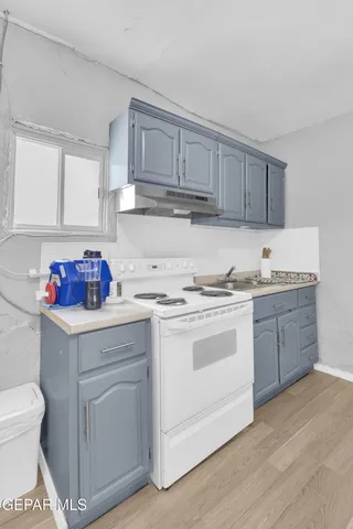 a view of a sink and cars parked in front of a house