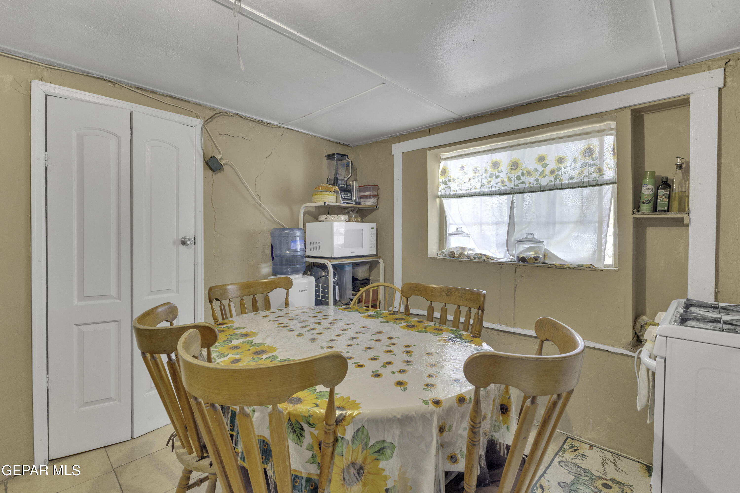 720 Johnson Street Fabens, TX 79838 - Photo 49 of 68 a dining room with furniture a large window and a wooden floor