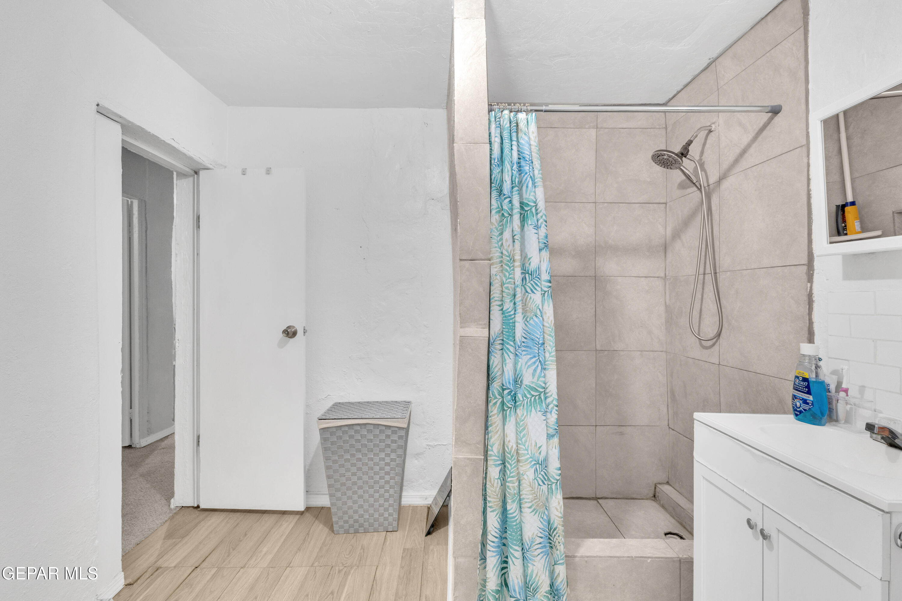 720 Johnson Street Fabens, TX 79838 - Photo 5 of 68 a bathroom with a shower curtain and a sink