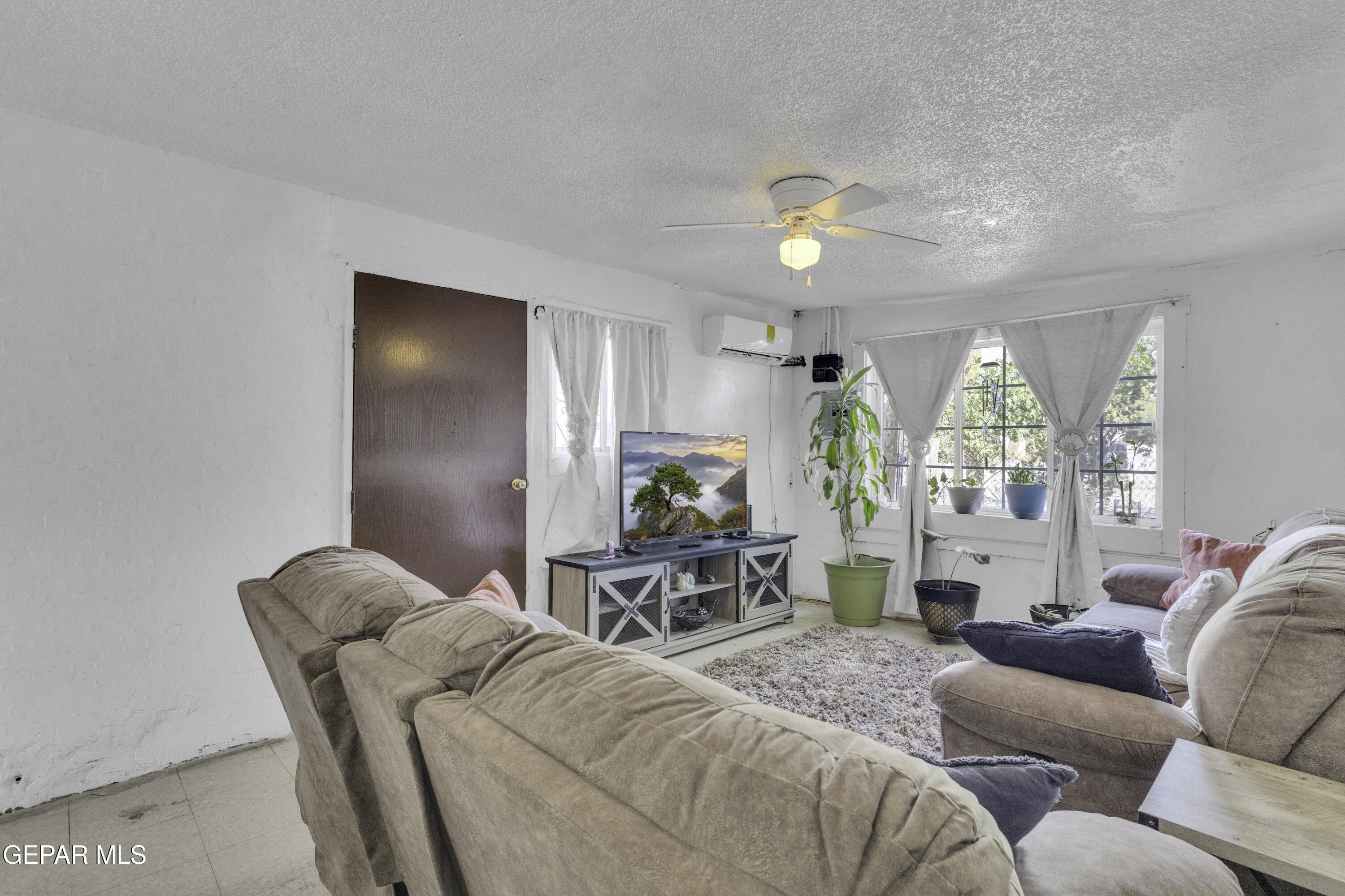 720 Johnson Street Fabens, TX 79838 - Photo 51 of 68 a living room with furniture a chandelier and a large window