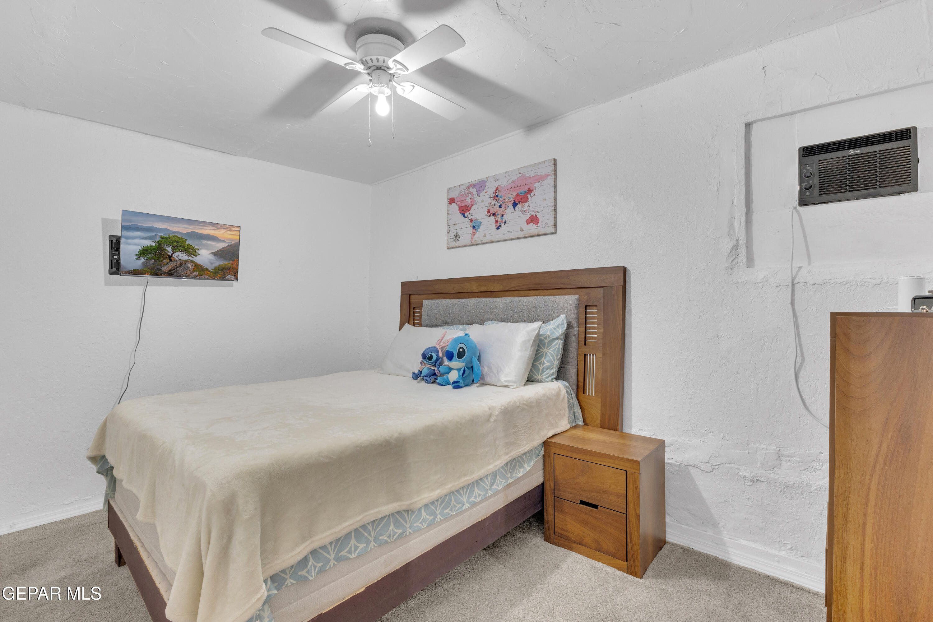 720 Johnson Street Fabens, TX 79838 - Photo 6 of 68 a bedroom with a bed and a chandelier