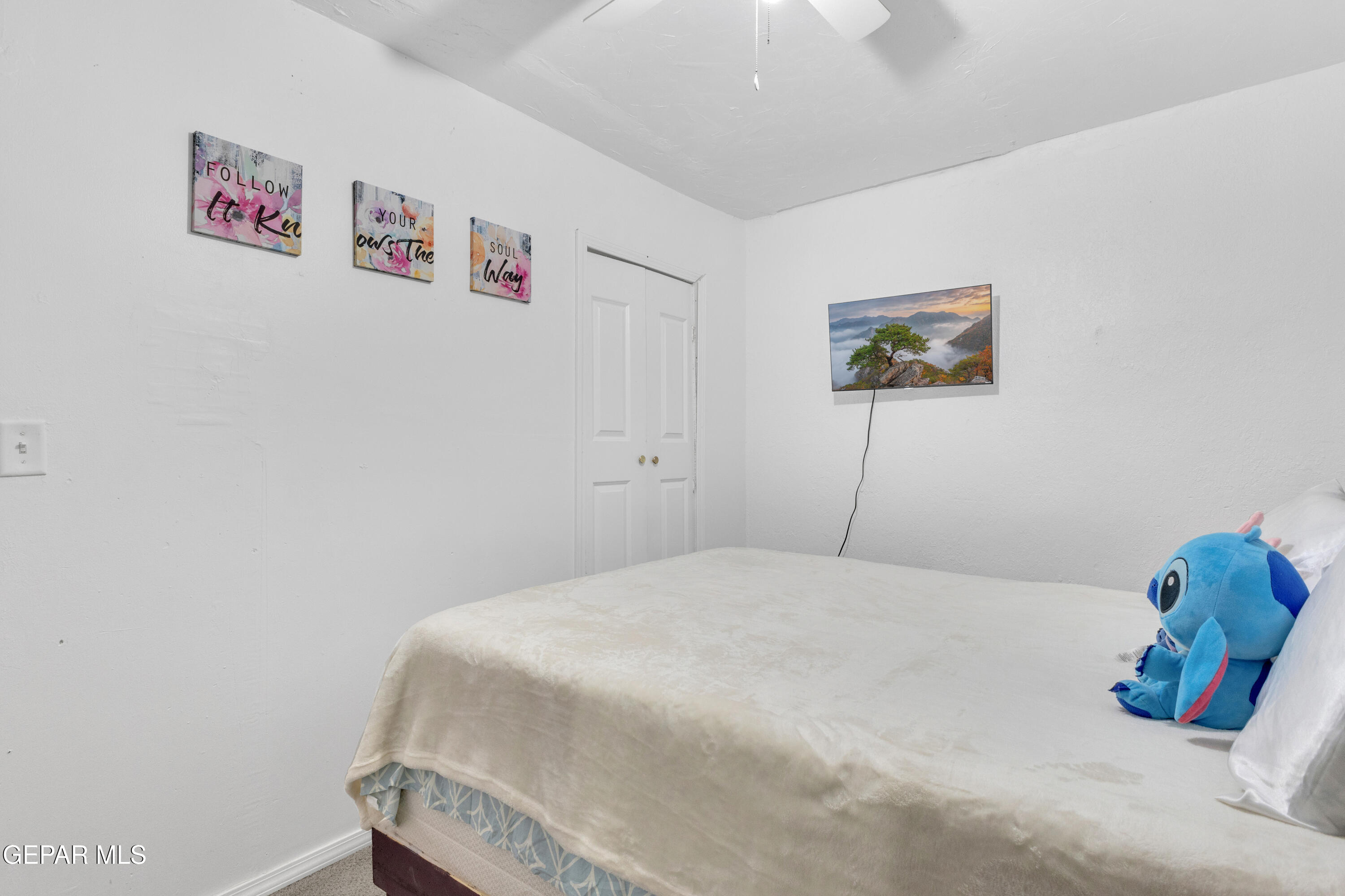 720 Johnson Street Fabens, TX 79838 - Photo 7 of 68 a bedroom with a bed and a wall painting