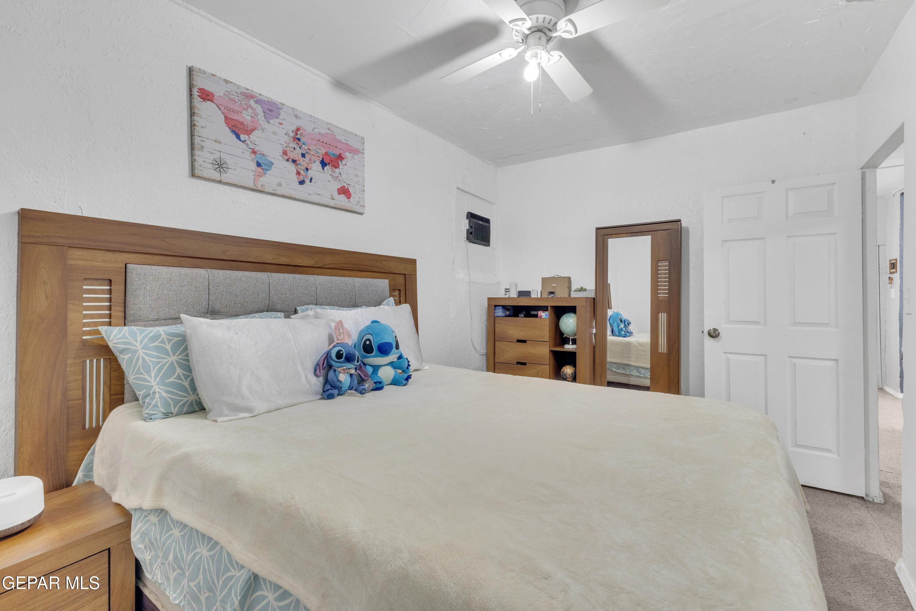 720 Johnson Street Fabens, TX 79838 - Photo 8 of 68 a bedroom with a large bed and a chandelier