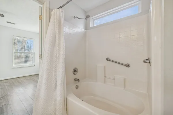 a white bath tub with a shower