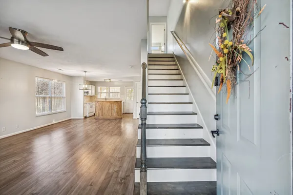 a view of an entryway with wooden floor
