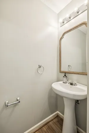 a bathroom with a sink a mirror and shower