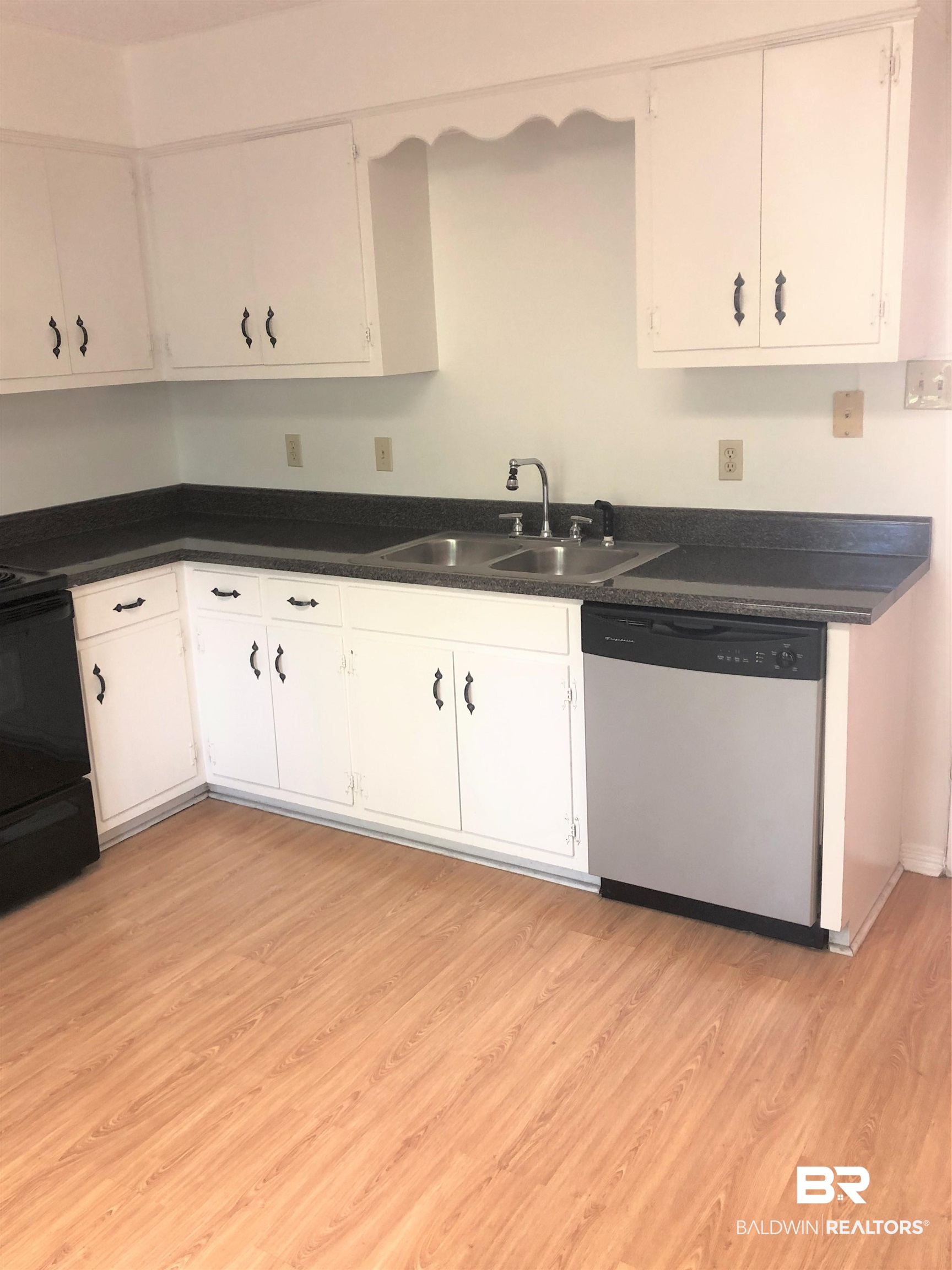 4009 Old Shell Road, Unit C12 Mobile, AL 36608 - Photo 6 of 11 Kitchen featuring white cabinets, sink, dishwasher, light wood-type flooring, and black range oven
