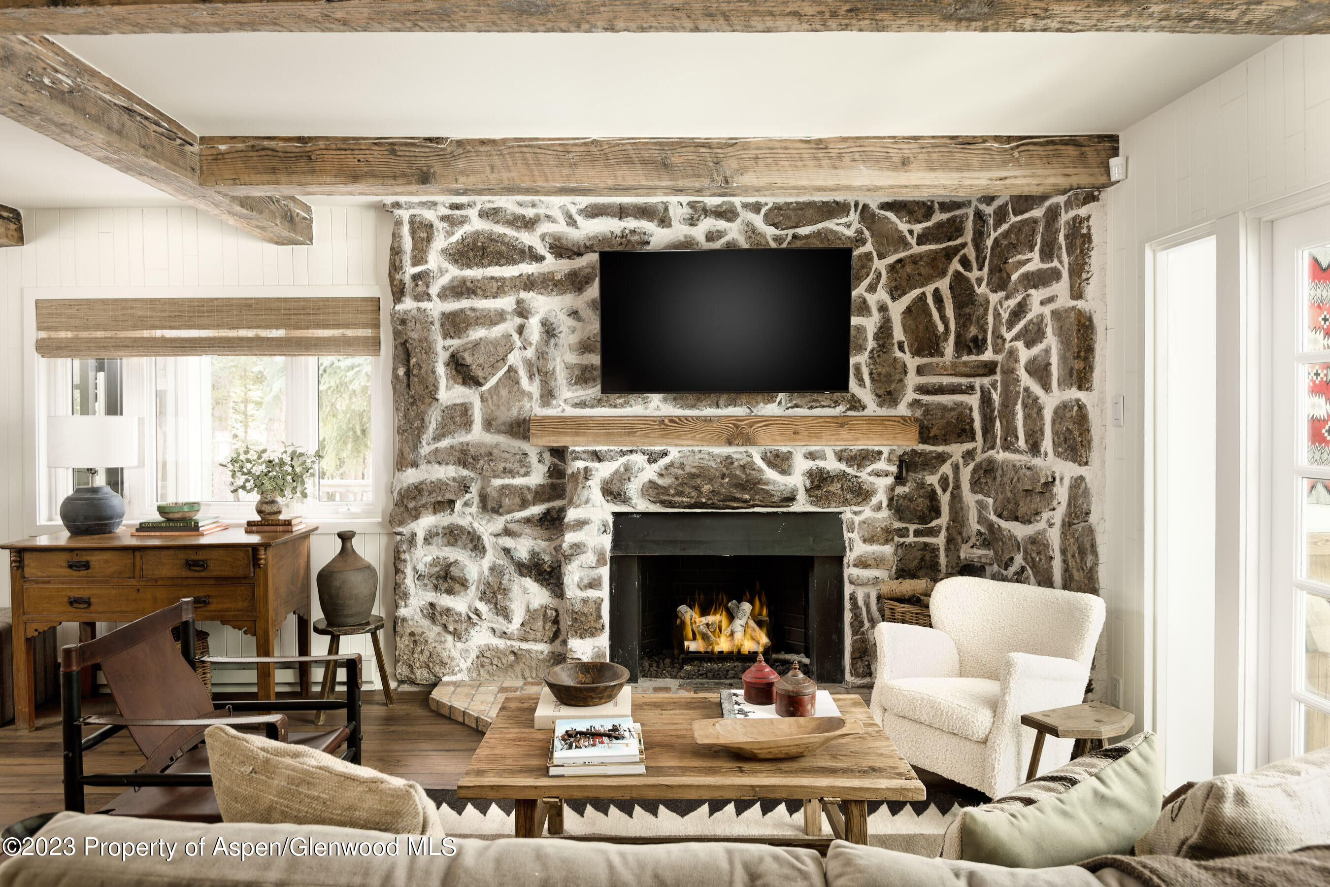 1470 Snowmass Creek Road Snowmass, CO 81654 - Photo 14 of 63 a living room with furniture a flat screen tv and a fireplace
